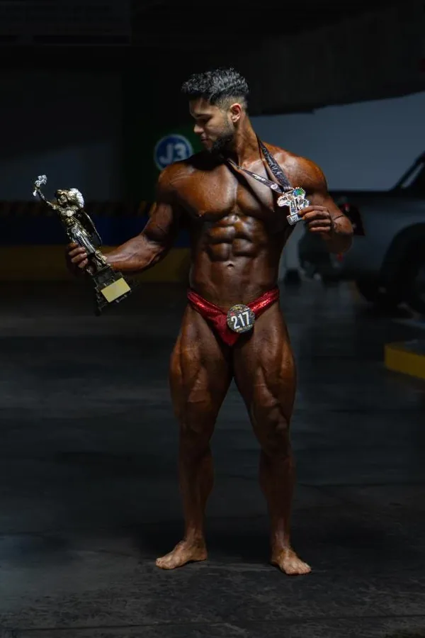 Kinetix athlete with his first-place trophy and medal